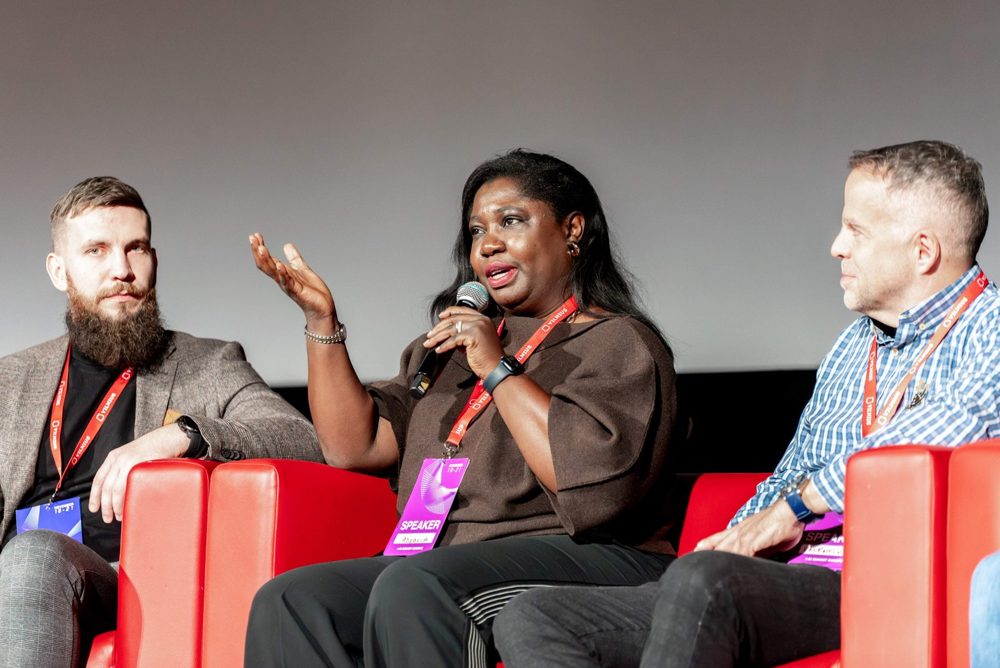 Panel discussion on stage with three speakers