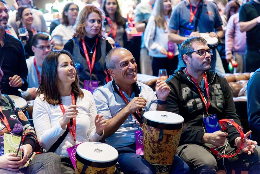 Audience taking part in an interactive drumming session