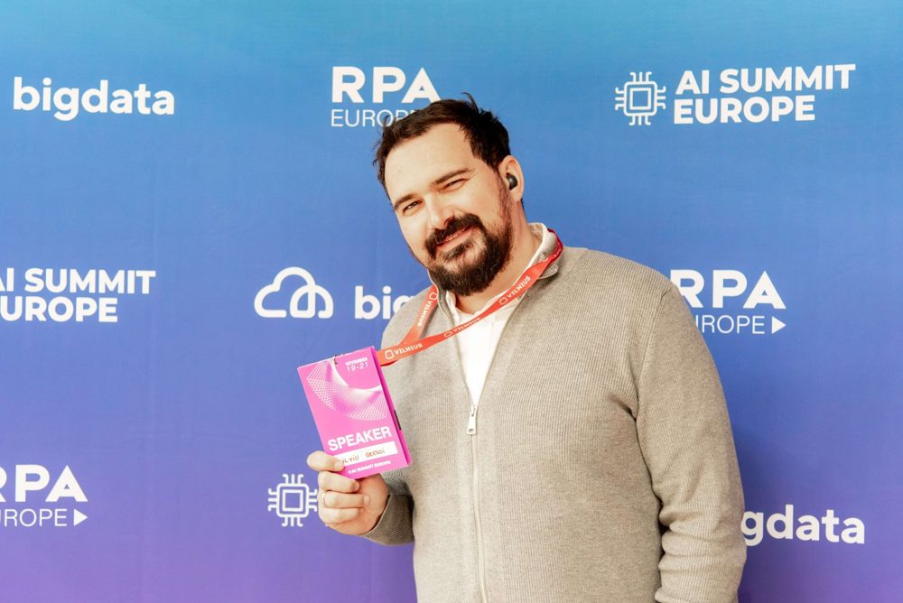 Attendee posing at the AI Summit Europe photo wall