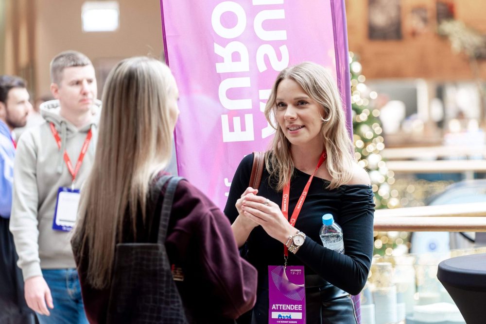 Attendees networking in the conference foyer
